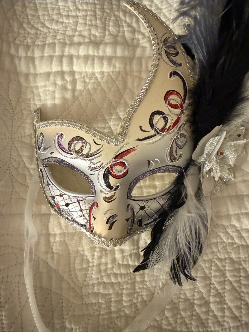 White Feathered Venetian Masquerade Mask with Black and Red Accents